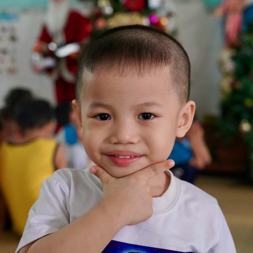Child smiling during a Happy Planet Children visit